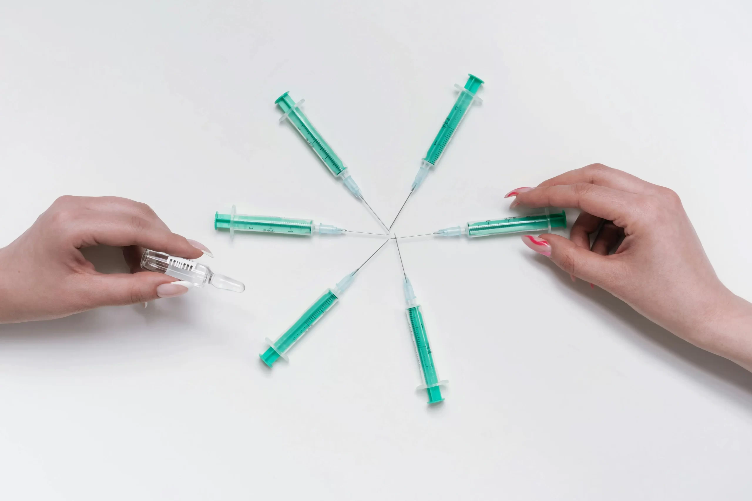Syringes lined up in a circle facing each other.